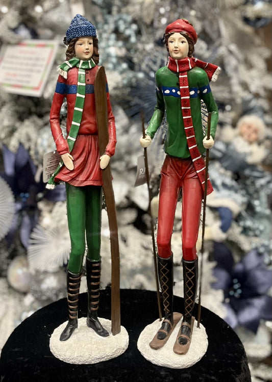 WOMAN STANDING WITH SKIIS ON BASE 4311325