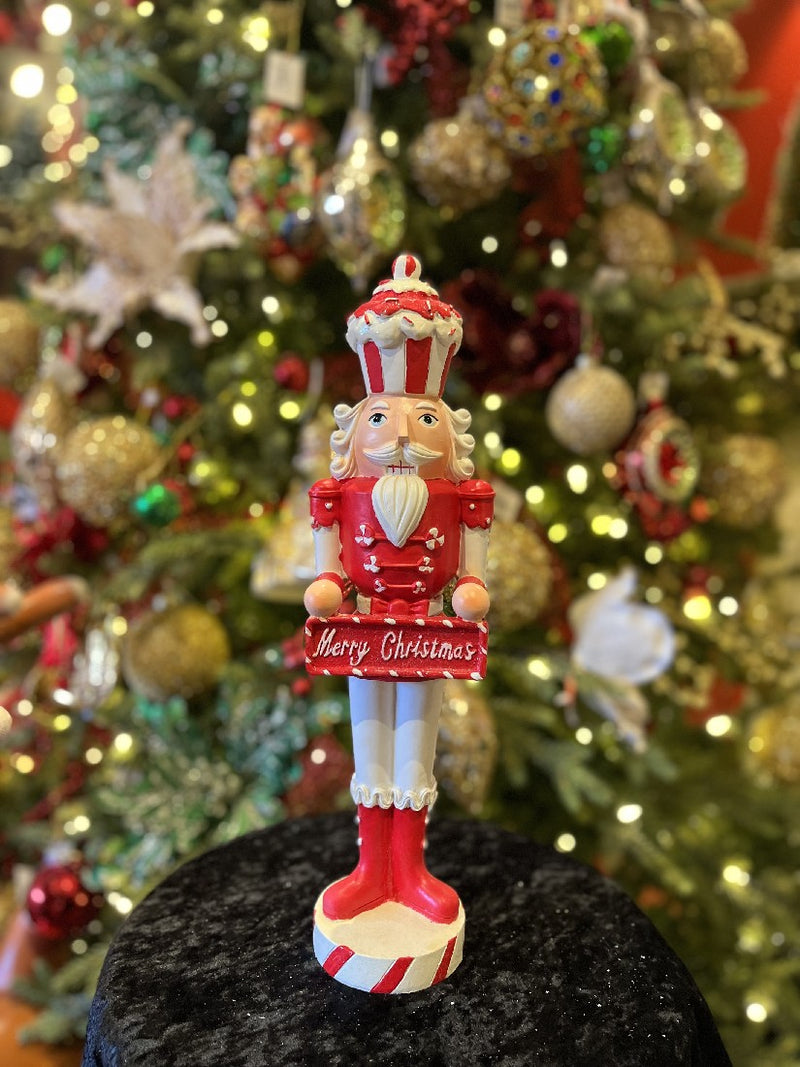 JINGLE & COCOA RED/WHITE NUTCRACKER WITH MERRY CHRISTMAS SIGN 15.5 INCH 4211587