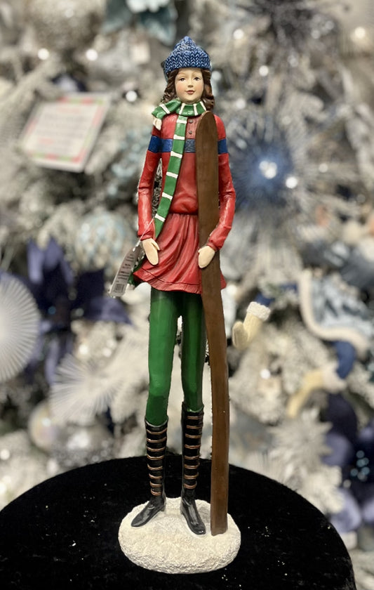WOMAN STANDING WITH SKIIS ON BASE 4311325