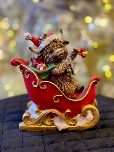 HIGHLAND COW IN SLEIGH WITH BELL 26771