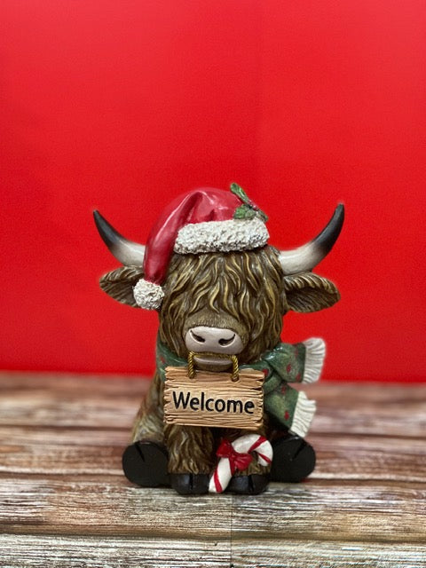 CHRISTMAS HIGHLAND COW SITTING WITH WELCOME SIGN 27601