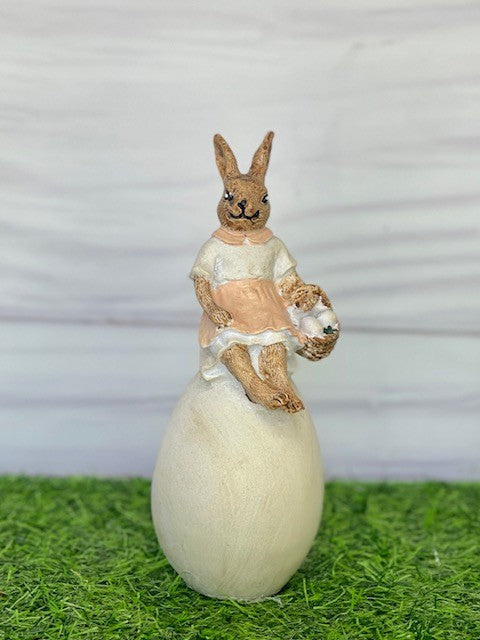 BUNNY GIRL WITH BASKET SITTING ON EGG EA07052